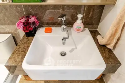 Modern bathroom sink with elegant marble countertop and stylish faucet