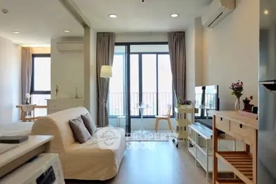 Modern open-plan living room with balcony and stylish decor