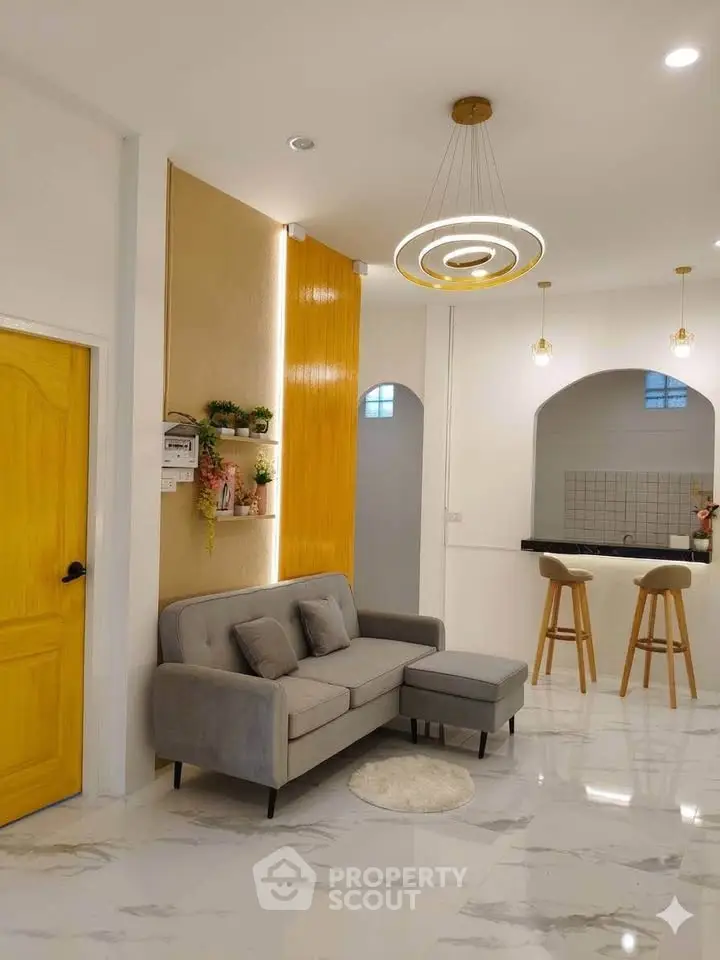 Modern living room with stylish lighting and open kitchen layout