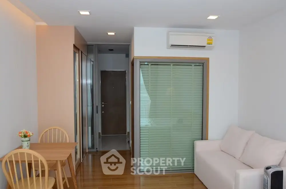 Cozy modern living room with wooden flooring and air conditioning