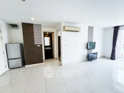 Spacious modern living room with air conditioning and balcony access in a stylish apartment.