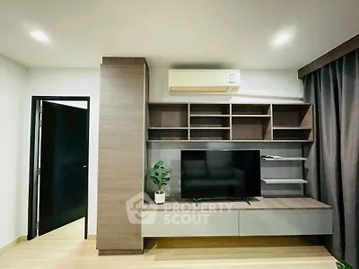 Modern living room with sleek TV unit and air conditioning