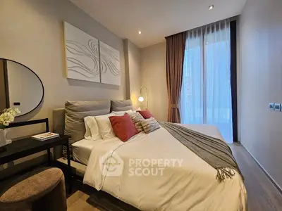 Luxurious bedroom with modern decor and large window offering natural light.