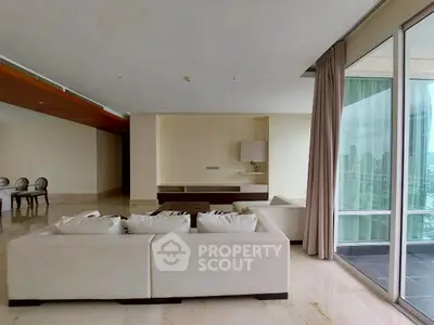 Spacious living room with modern decor and city view balcony