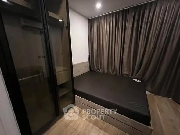 Modern bedroom with sleek design, featuring a large bed and floor-to-ceiling curtains for a cozy ambiance.