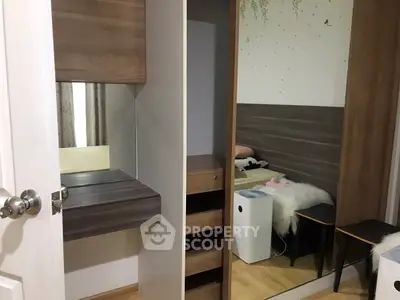 Modern bedroom with stylish wooden furniture and mirrored wardrobe