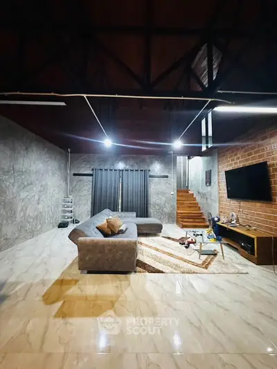 Spacious modern living room with stylish decor and cozy seating area.