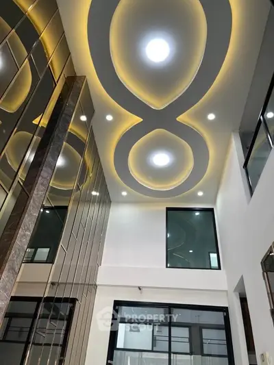 Stunning modern interior with unique ceiling design and elegant lighting.