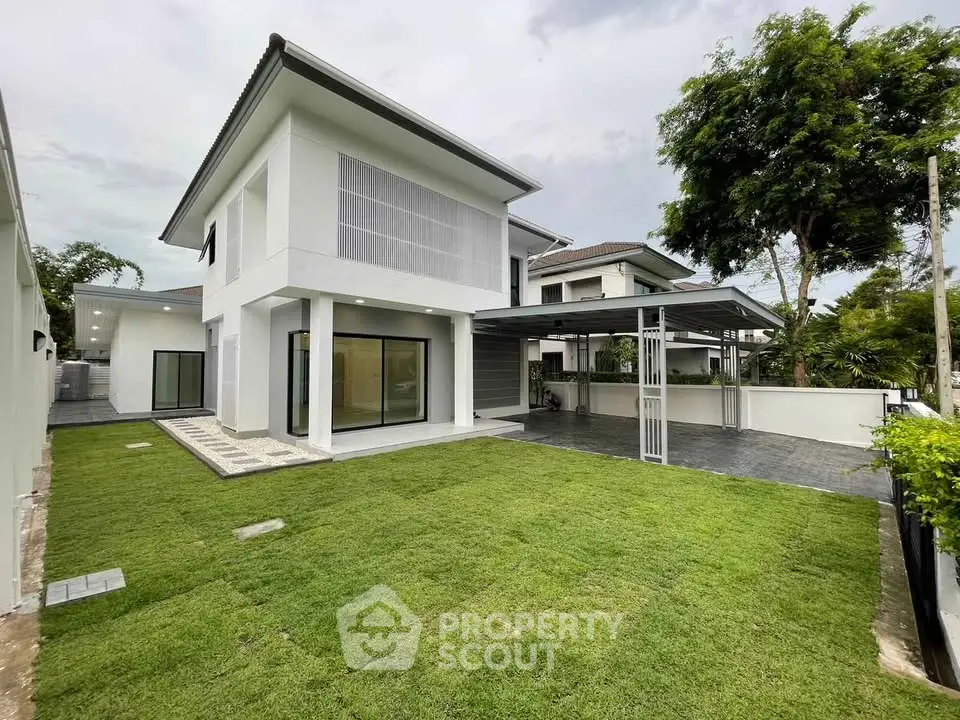 Modern two-story house with spacious lawn and sleek design in a serene neighborhood.