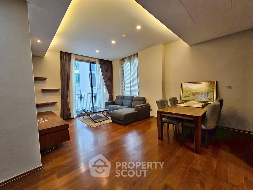 Spacious modern living room with wooden flooring and elegant furniture
