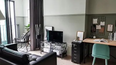 Stylish modern living room with TV, desk, and balcony access, perfect for urban living.