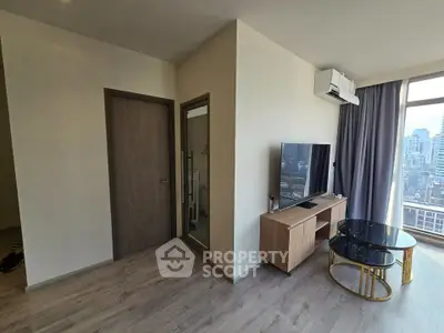 Modern living room with city view, featuring sleek furniture and large windows.