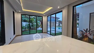 Luxurious modern living room with pool view and elegant marble countertop