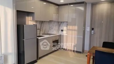 Modern kitchen with sleek cabinetry and integrated appliances in a stylish apartment.