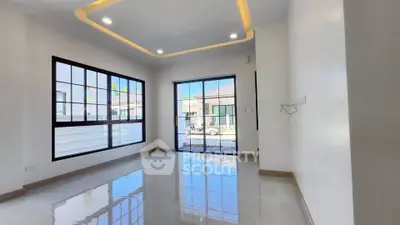 Spacious modern living room with large windows and glossy tile flooring