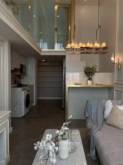 Luxurious loft apartment with modern kitchen and stylish living area, featuring elegant lighting and chic decor.