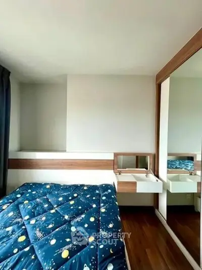 Modern bedroom with stylish decor and large mirror wardrobe