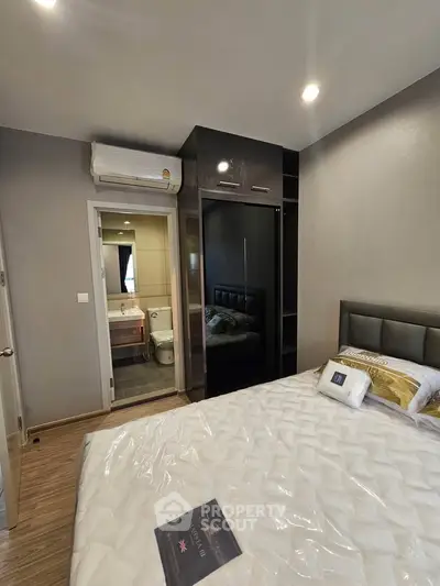 Modern bedroom with ensuite bathroom and sleek wardrobe design