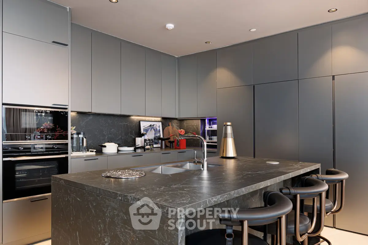 Luxurious modern kitchen with sleek cabinetry and marble island in high-end apartment.
