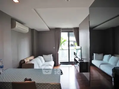 Modern living room with sleek design and balcony access in urban apartment