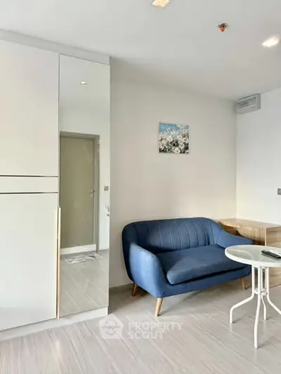 Modern living room with sleek blue sofa and stylish decor