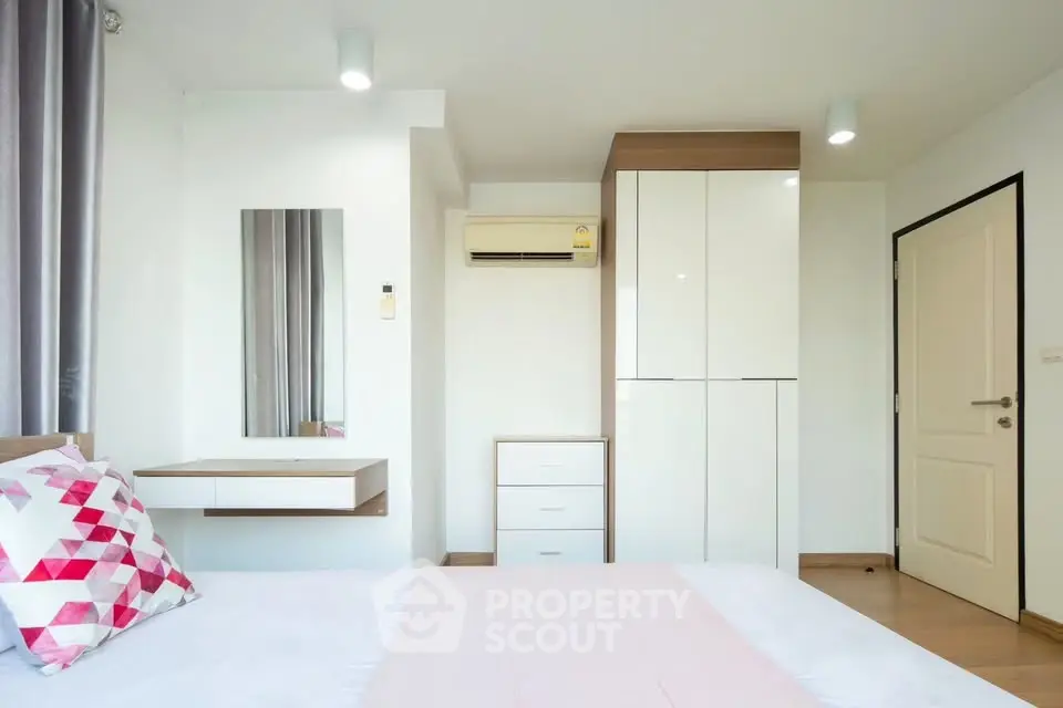 Modern bedroom with sleek wardrobe and minimalist decor