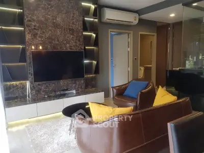 Luxurious living room with modern design, featuring leather seating and a sleek marble accent wall with TV.