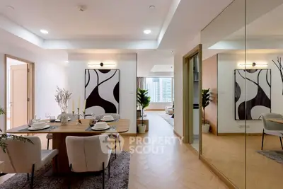Modern dining area with elegant decor and mirrored wall in a stylish apartment.