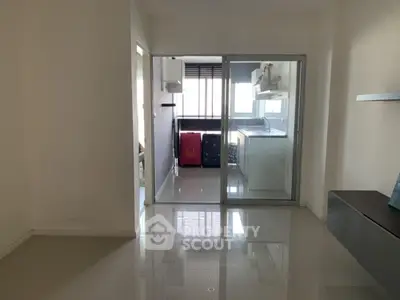 Modern apartment interior with sleek glass sliding doors and glossy tiled floors.