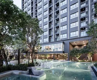 Luxurious modern building with stunning pool and lush greenery