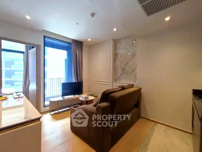 Modern living room with cozy sofa and TV, featuring a small balcony view.