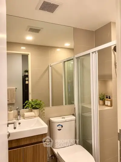 Modern bathroom with glass shower, sleek vanity, and neutral tones for a contemporary feel.
