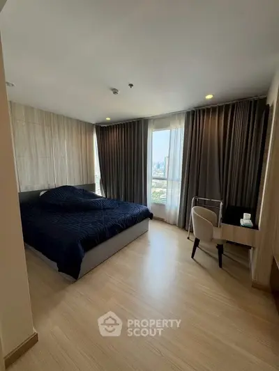 Spacious modern bedroom with city view and elegant furnishings