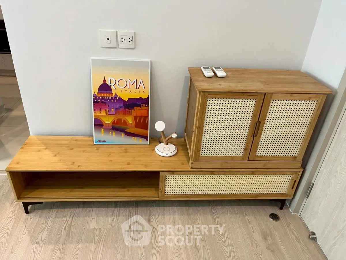 Stylish modern living room with wooden furniture and Roma Italia poster.