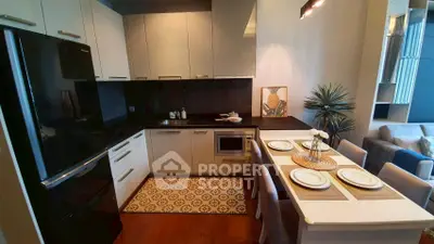 Modern kitchen with sleek cabinets and dining area in stylish apartment