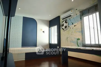 Modern bedroom with unique wall design and wooden flooring, featuring a built-in bed and air conditioning.