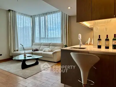 Modern living room with cozy sofa and stylish kitchen bar