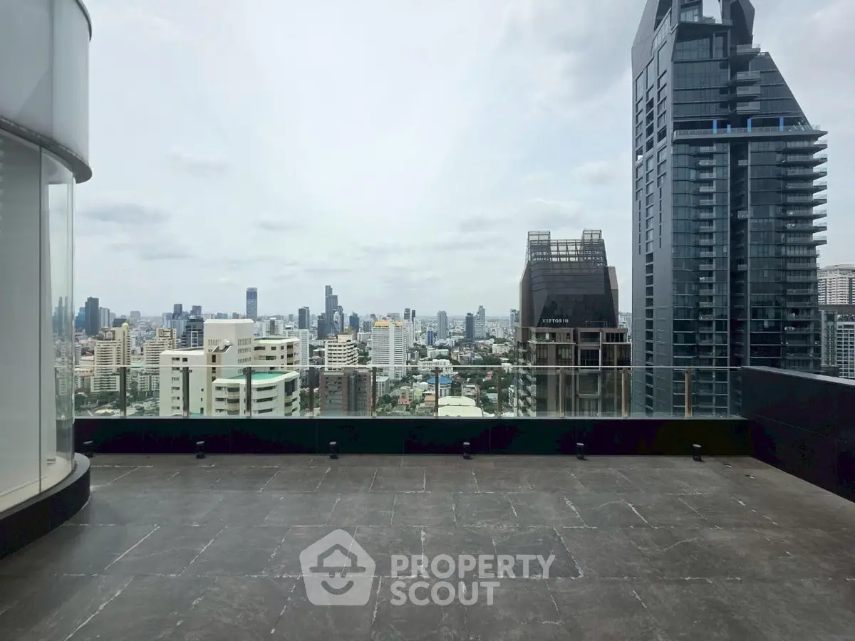 Stunning cityscape view from a spacious rooftop terrace in a modern urban setting.