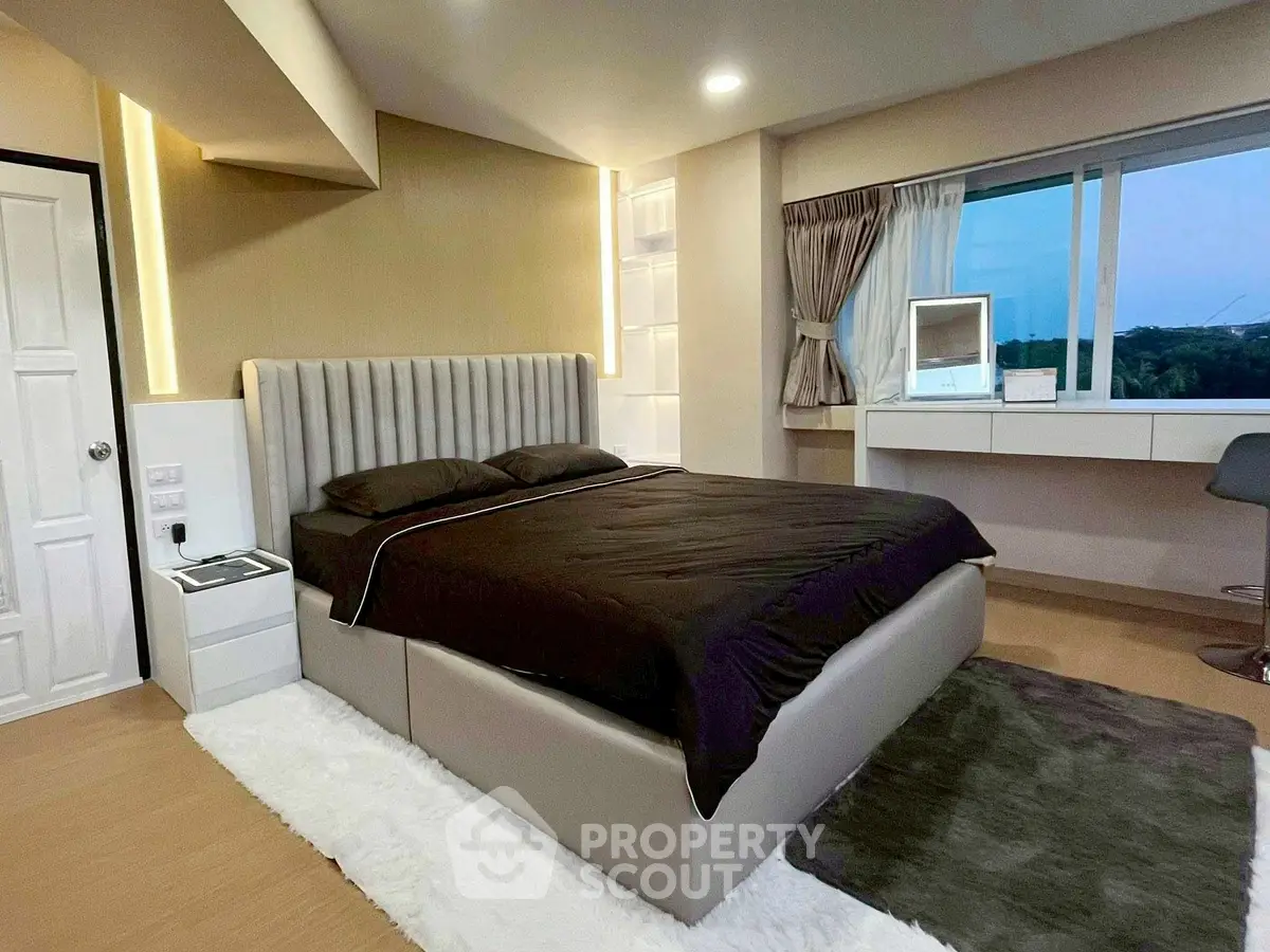 Luxurious bedroom with modern decor and scenic window view