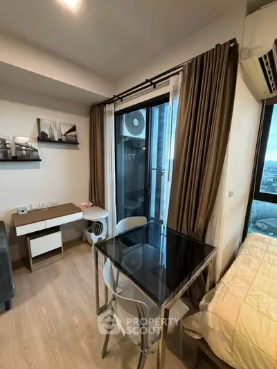 Modern compact living room with glass table and city view balcony