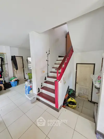 Charming interior with unique staircase and ample storage space, perfect for creative home design.