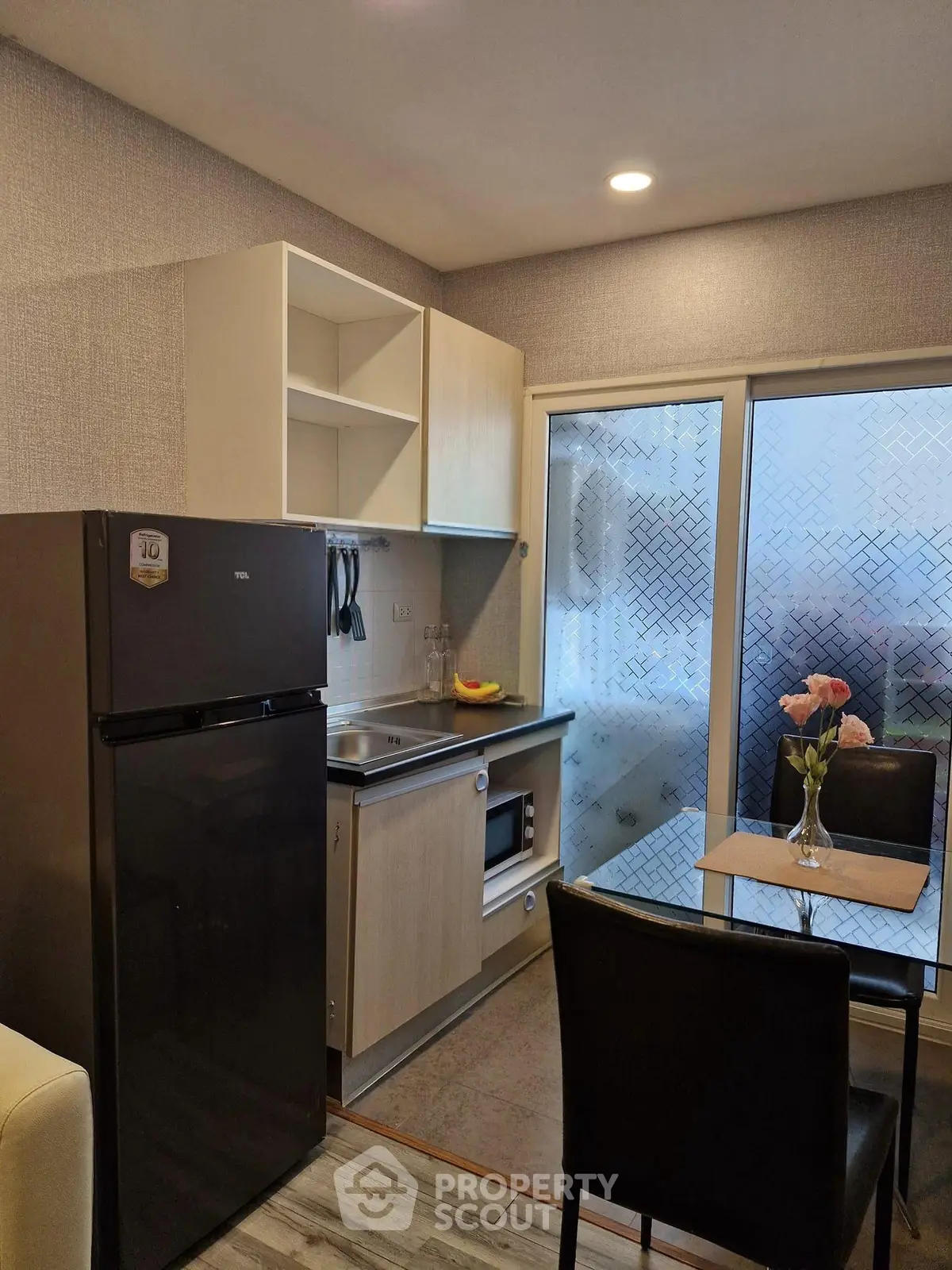 Modern kitchen with sleek appliances and cozy dining area, perfect for urban living.