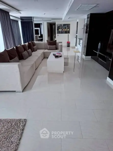 Spacious modern living room with sleek design and large sectional sofa.