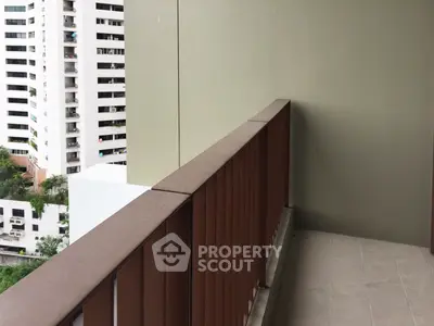 Spacious balcony with city view in modern apartment building