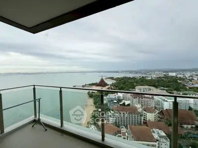 Stunning high-rise balcony view overlooking the ocean and cityscape, perfect for luxury living.