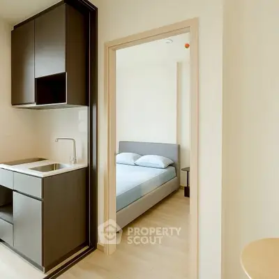 Modern compact apartment with sleek kitchen and cozy bedroom