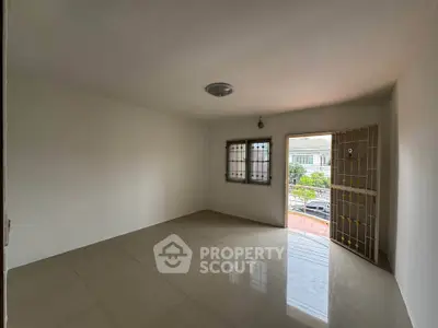 Spacious empty room with tiled floor and natural light, ideal for customization.