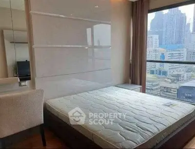 Modern bedroom with city view, featuring a comfortable bed and sleek design in a high-rise apartment.