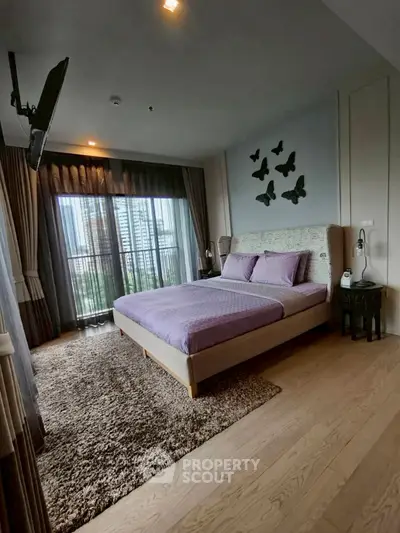 Luxurious bedroom with city view, elegant decor, and plush carpeting in modern apartment.