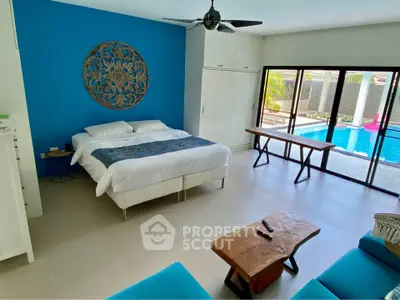 Spacious bedroom with pool view and modern decor in luxury home